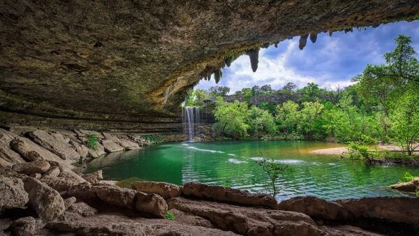 A 50 foot waterfall carved a beautiful grotto style swimming hole from the Texas limestone.